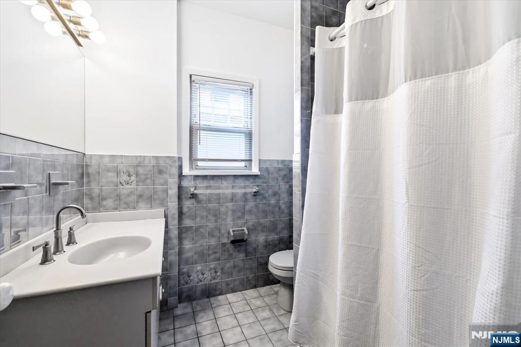 119 Overpeck Avenue Ridgefield Park, NJ 07660 - Photo 29 of 44 a bathroom with a sink toilet and shower