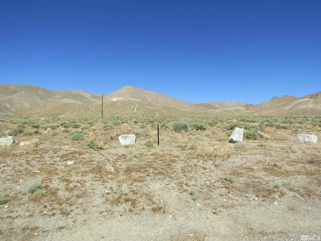 a view of a large mountain with mountains in the background