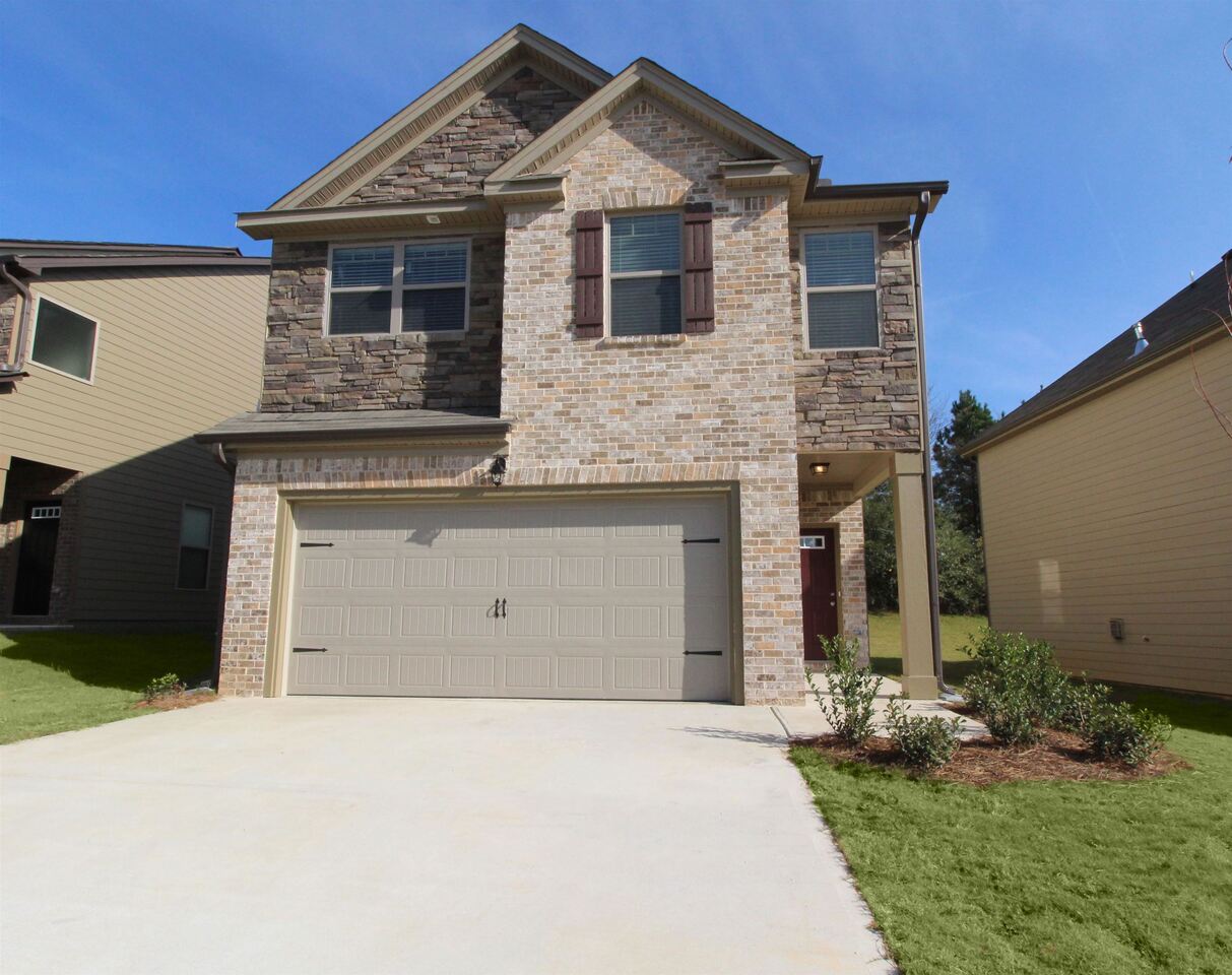 3443 Sycamore Bend, Unit 50 Decatur, GA 30034 - Photo 1 of 1 a front view of a house with a yard and garage