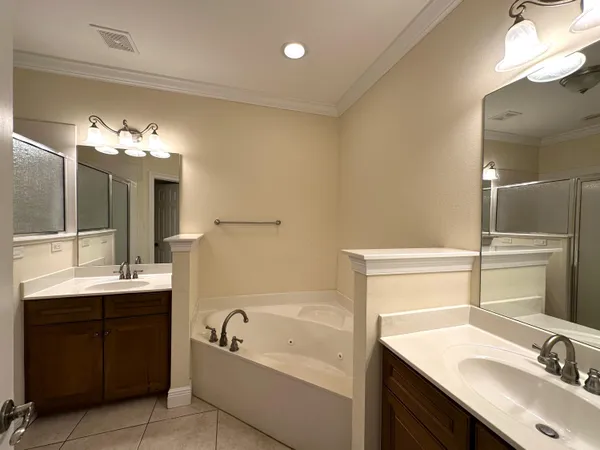 a bathroom with a tub sink and mirror
