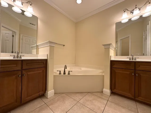 a bathroom with a bathtub sink and a mirror