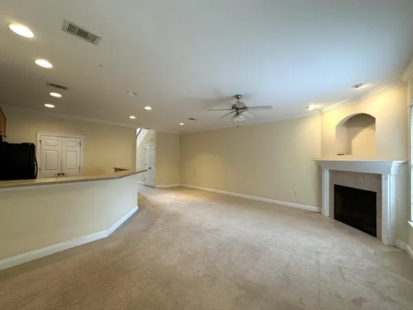 a view of an empty room with a fireplace