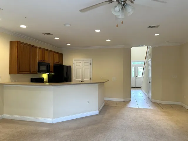 a view of kitchen with stainless steel appliances a refrigerator and a stove top oven