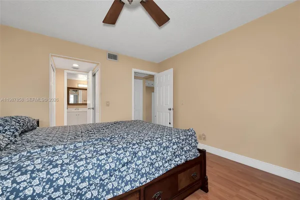 a view of a hallway with wooden floor and closet