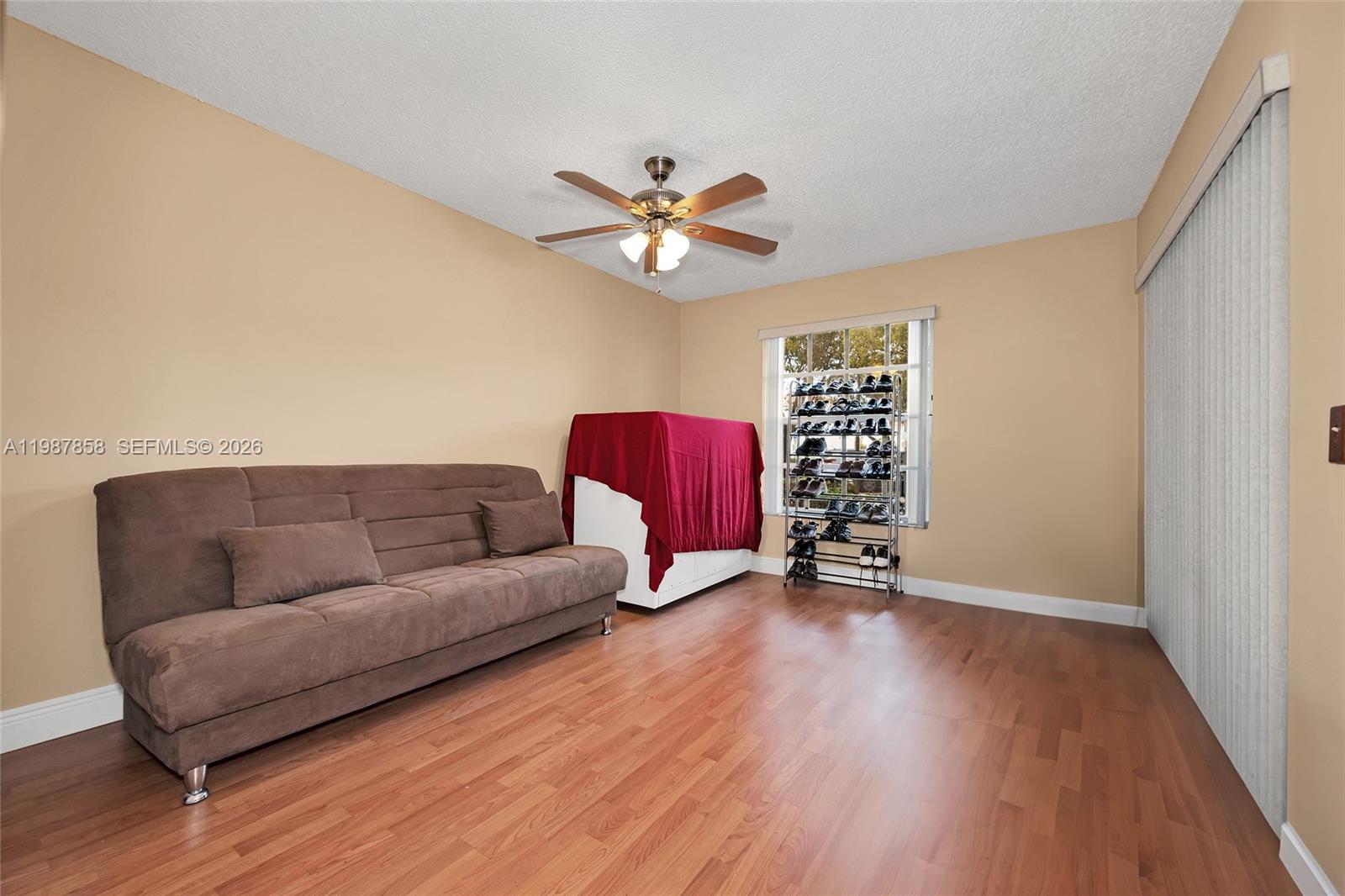 10441 Mahogany Key Circle, Unit 101 Miami, FL 33196 - Photo 17 of 26 a living room with furniture and a ceiling fan