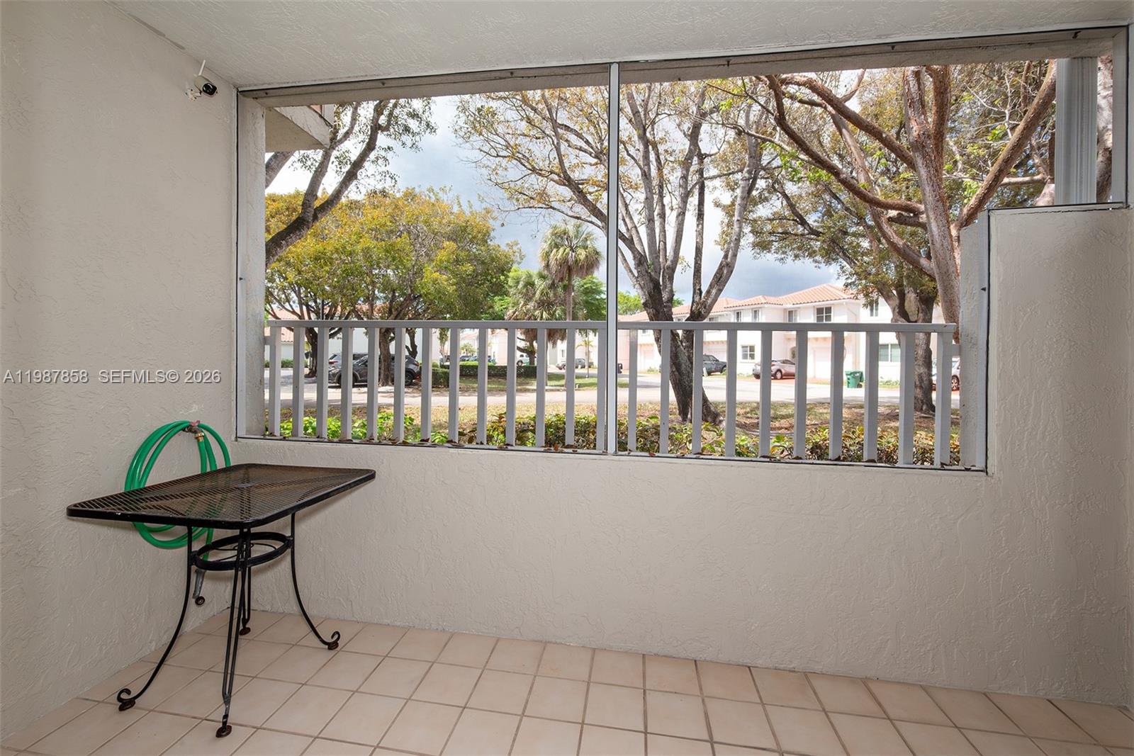 10441 Mahogany Key Circle, Unit 101 Miami, FL 33196 - Photo 20 of 26 a view of a room with furniture and wooden fence