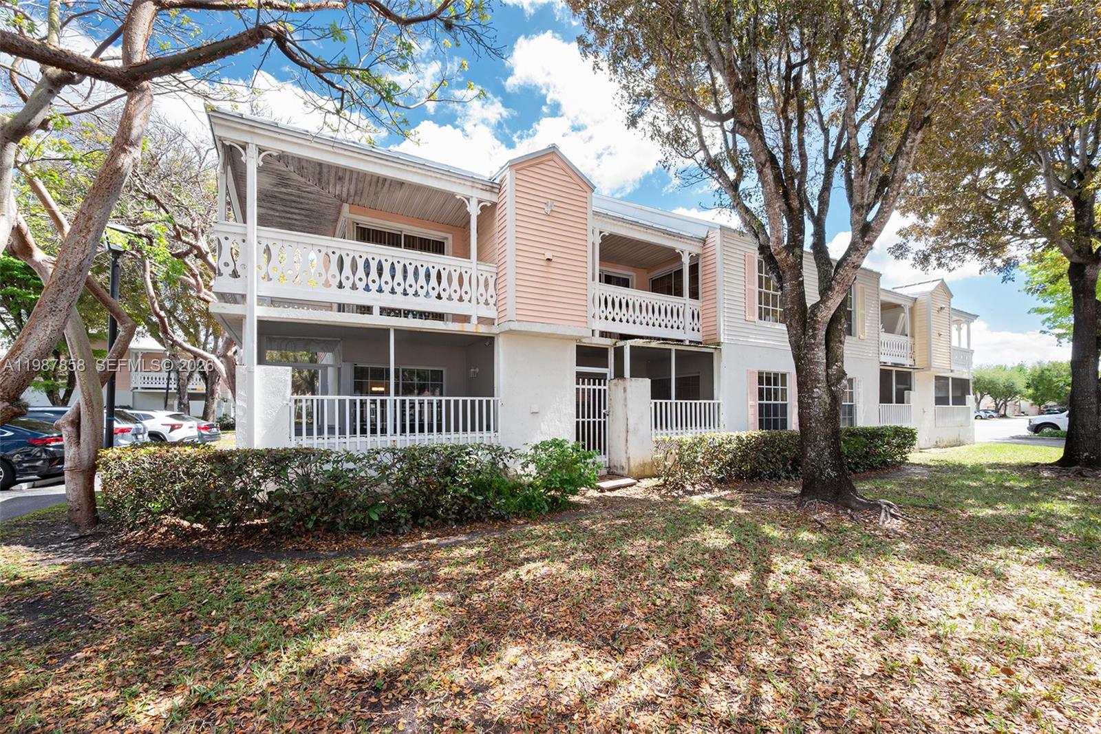 10441 Mahogany Key Circle, Unit 101 Miami, FL 33196 - Photo 2 of 26 a front view of a house with a garden