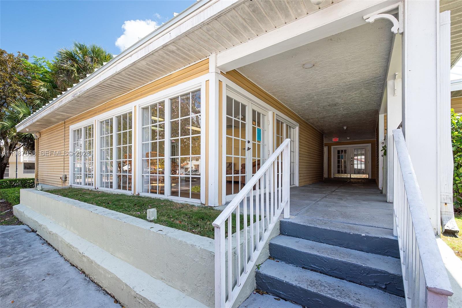 10441 Mahogany Key Circle, Unit 101 Miami, FL 33196 - Photo 25 of 26 a view of a house with stairs and a table