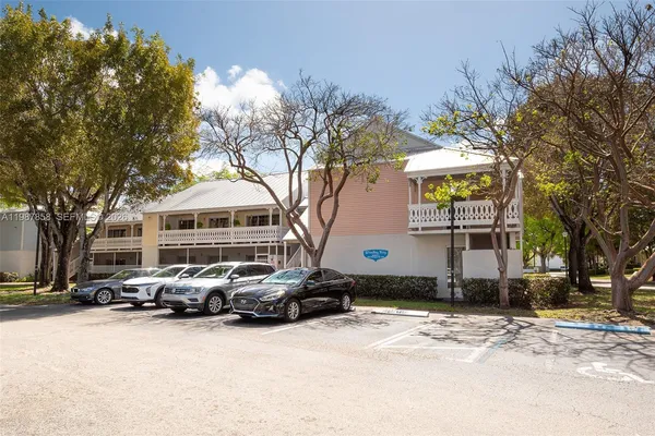 a front view of a house with a yard covered with snow