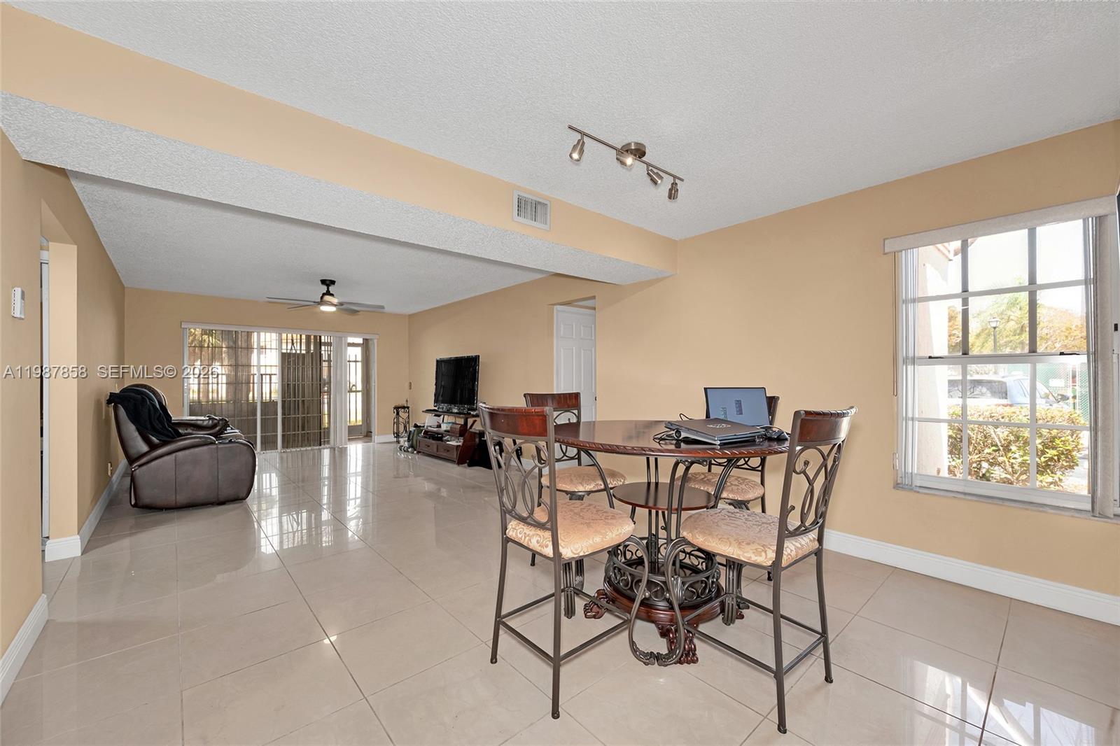 10441 Mahogany Key Circle, Unit 101 Miami, FL 33196 - Photo 6 of 26 a view of a dining room with furniture window and outside view