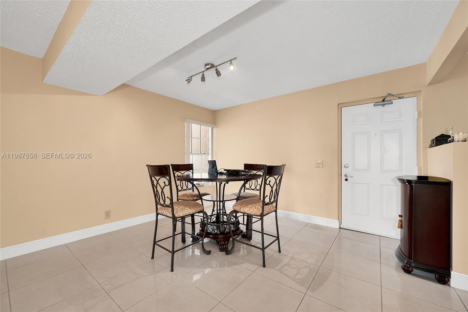 10441 Mahogany Key Circle, Unit 101 Miami, FL 33196 - Photo 7 of 26 a view of a dining room with furniture