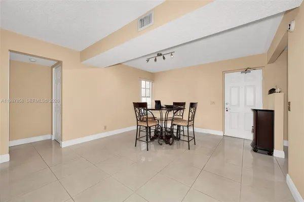 a kitchen with cabinets stainless steel appliances and a refrigerator