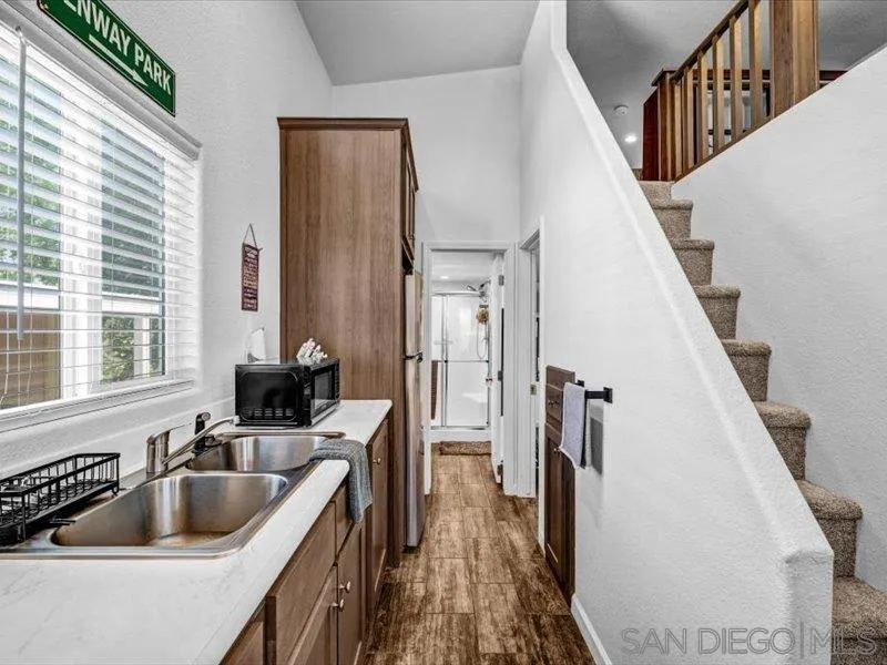 14291 Rios Canyon Road, Unit 3 El Cajon, CA 92021 - Photo 13 of 16 a kitchen with sink cabinets and refrigerator