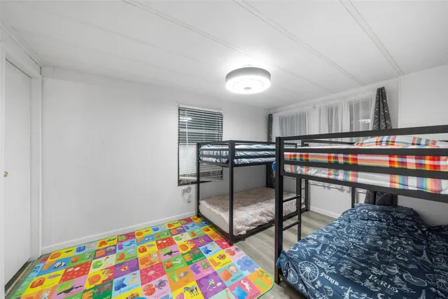 a bedroom with a bed and a dresser in it