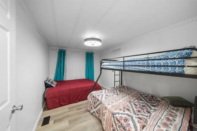 a bedroom with a large bed and a window