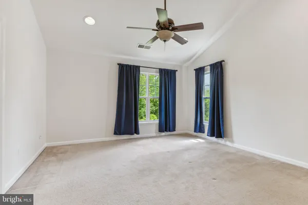 an empty room with view of ceiling fan