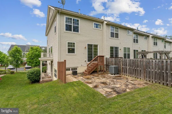 a view of a house with backyard porch and sitting area