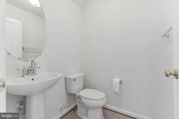 a bathroom with a sink toilet and mirror