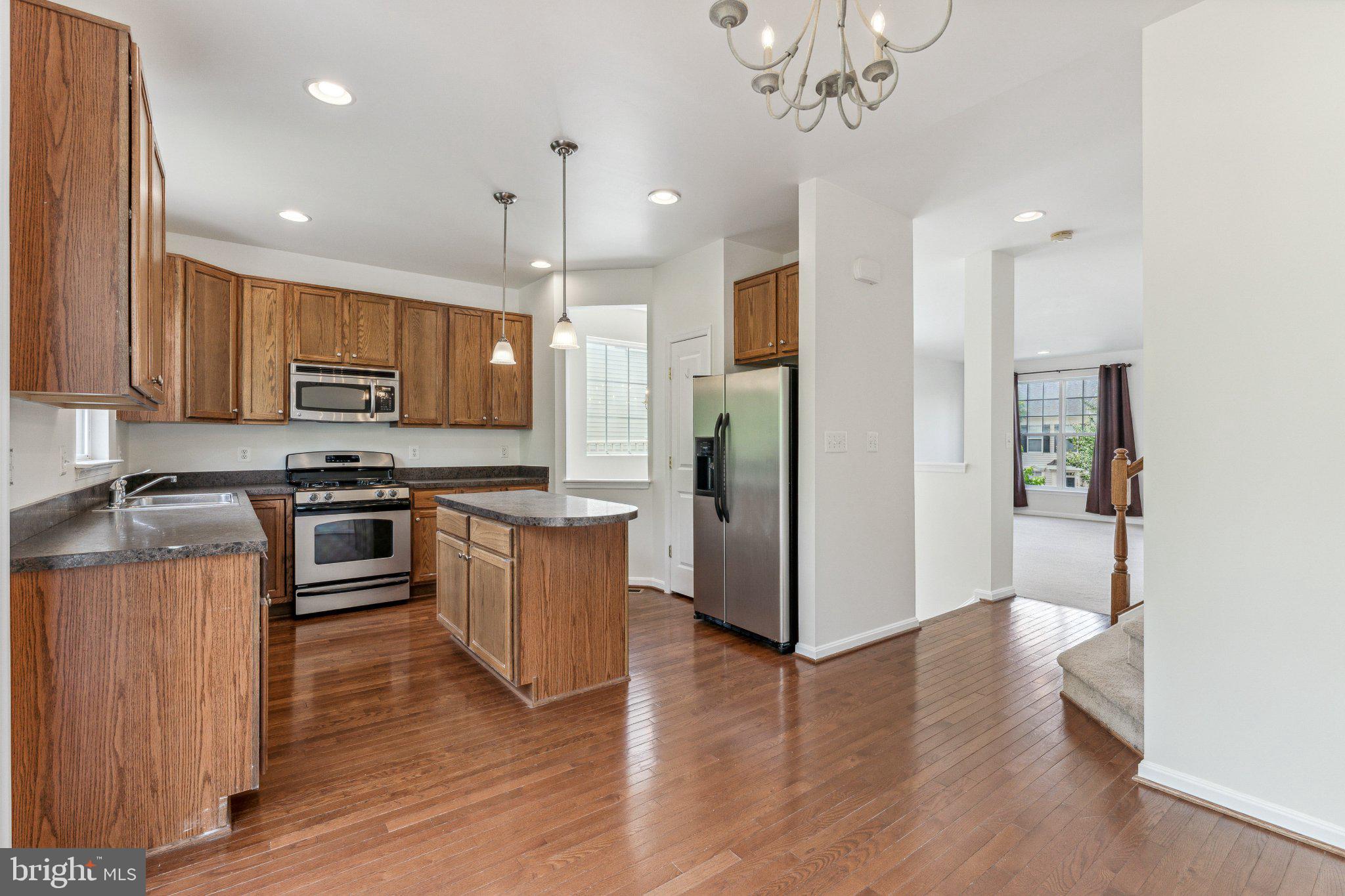 11896 Benton Lake Road Bristow, VA 20136 - Photo 10 of 27 Modern kitchen with warm wood tones.