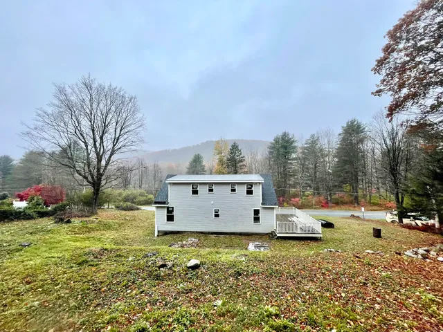a view of a tiny house with a yard