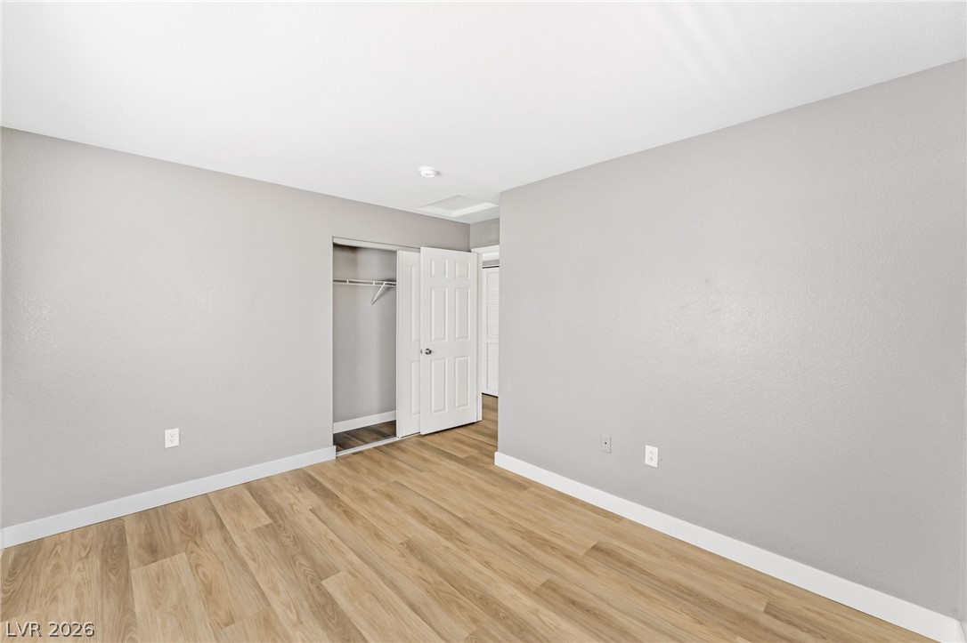 3318 North Decatur Boulevard, Unit 2152 Las Vegas, NV 89130 - Photo 25 of 58 A well-lit bedroom features durable laminate flooring and ample closet space, ready for personalization.