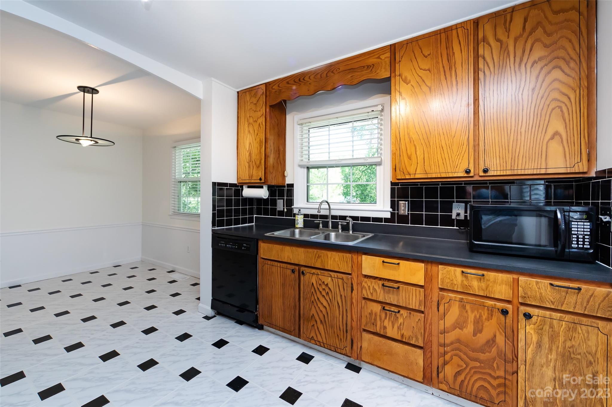 1506 Rama Road Charlotte, NC 28211 - Photo 13 of 48 a kitchen with granite countertop a sink a stove a refrigerator a window with wooden floor and cabinets