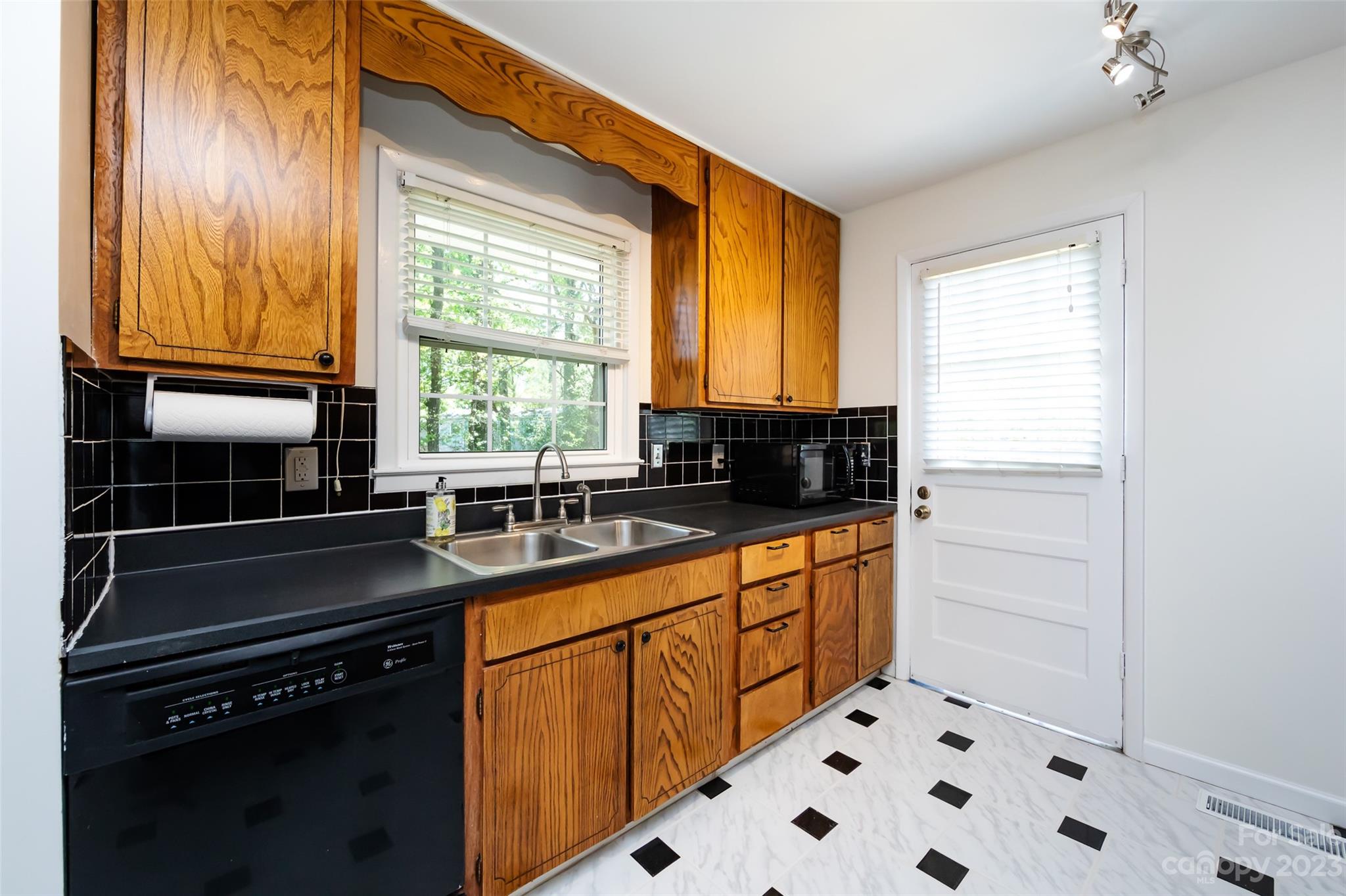 1506 Rama Road Charlotte, NC 28211 - Photo 15 of 48 a kitchen with granite countertop a sink and a window