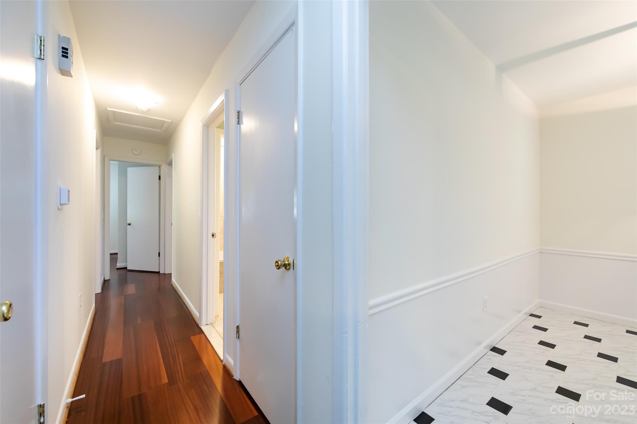 1506 Rama Road Charlotte, NC 28211 - Photo 19 of 48 a view of a hallway with wooden floor and a bathroom