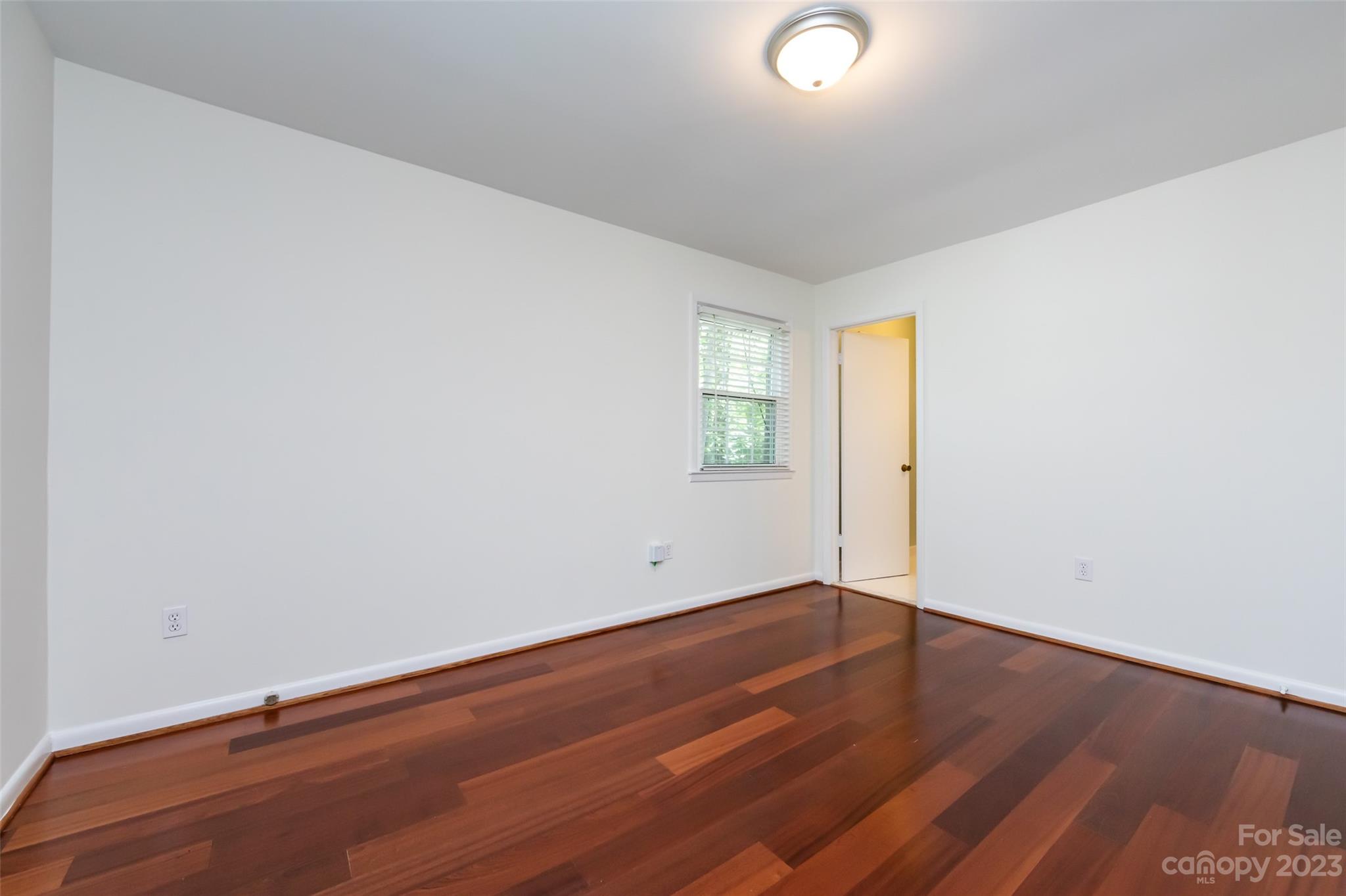 1506 Rama Road Charlotte, NC 28211 - Photo 21 of 48 an empty room with wooden floor and windows
