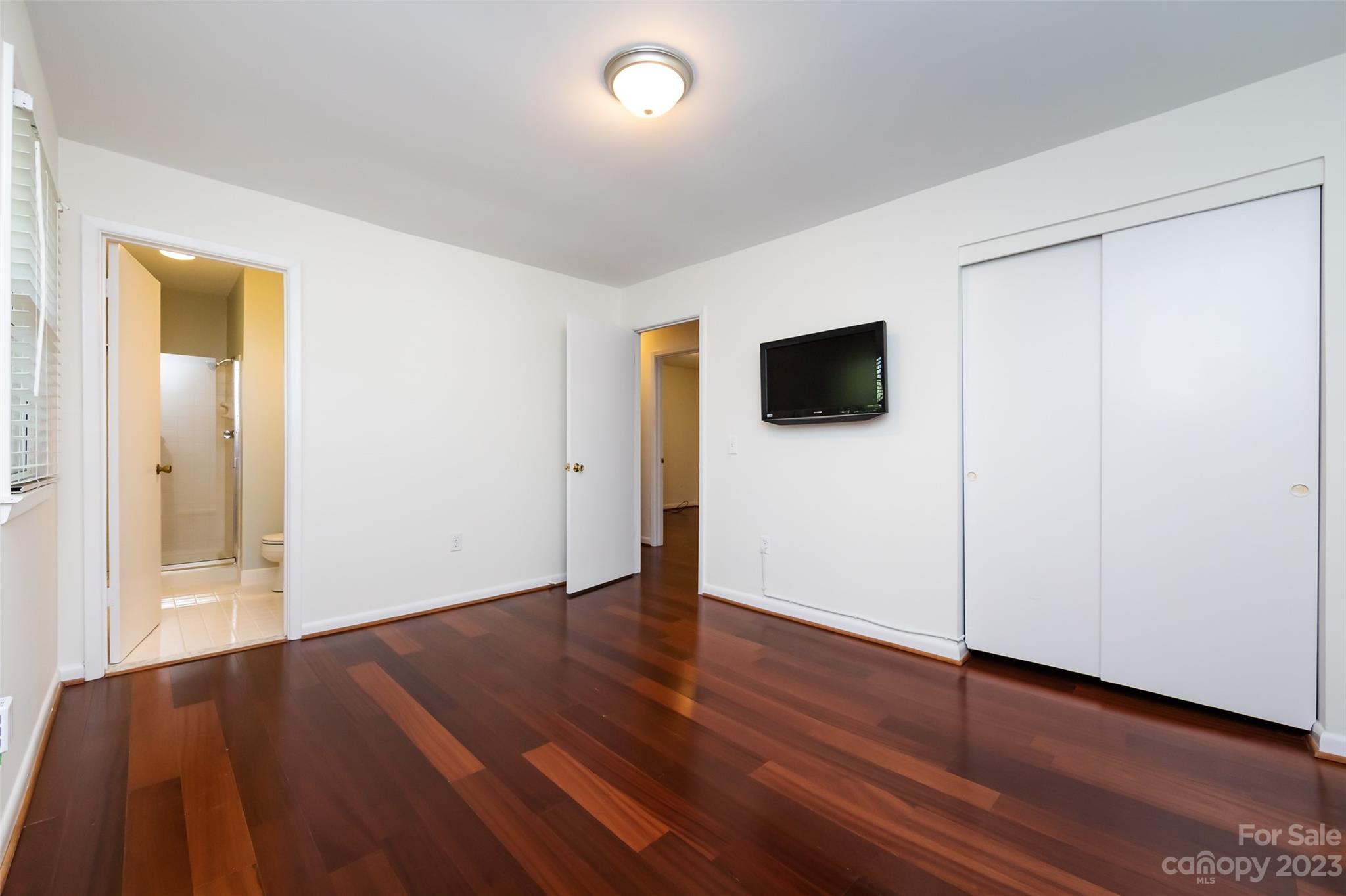 1506 Rama Road Charlotte, NC 28211 - Photo 22 of 48 an empty room with wooden floor and windows