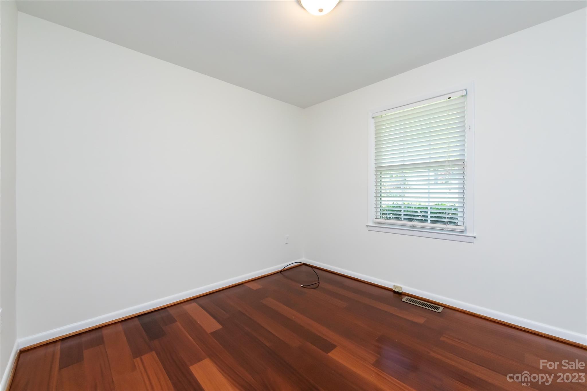 1506 Rama Road Charlotte, NC 28211 - Photo 25 of 48 an empty room with wooden floor and windows