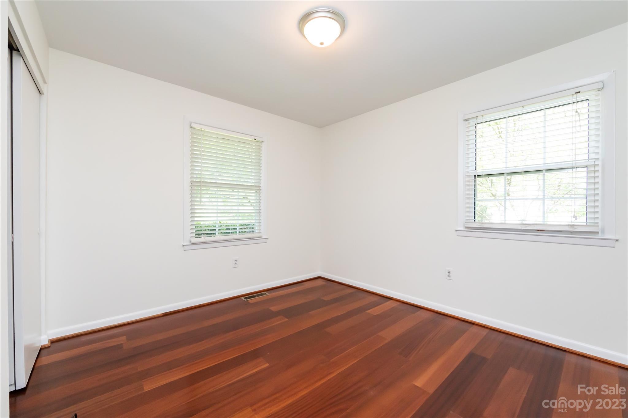 1506 Rama Road Charlotte, NC 28211 - Photo 28 of 48 an empty room with wooden floor and windows