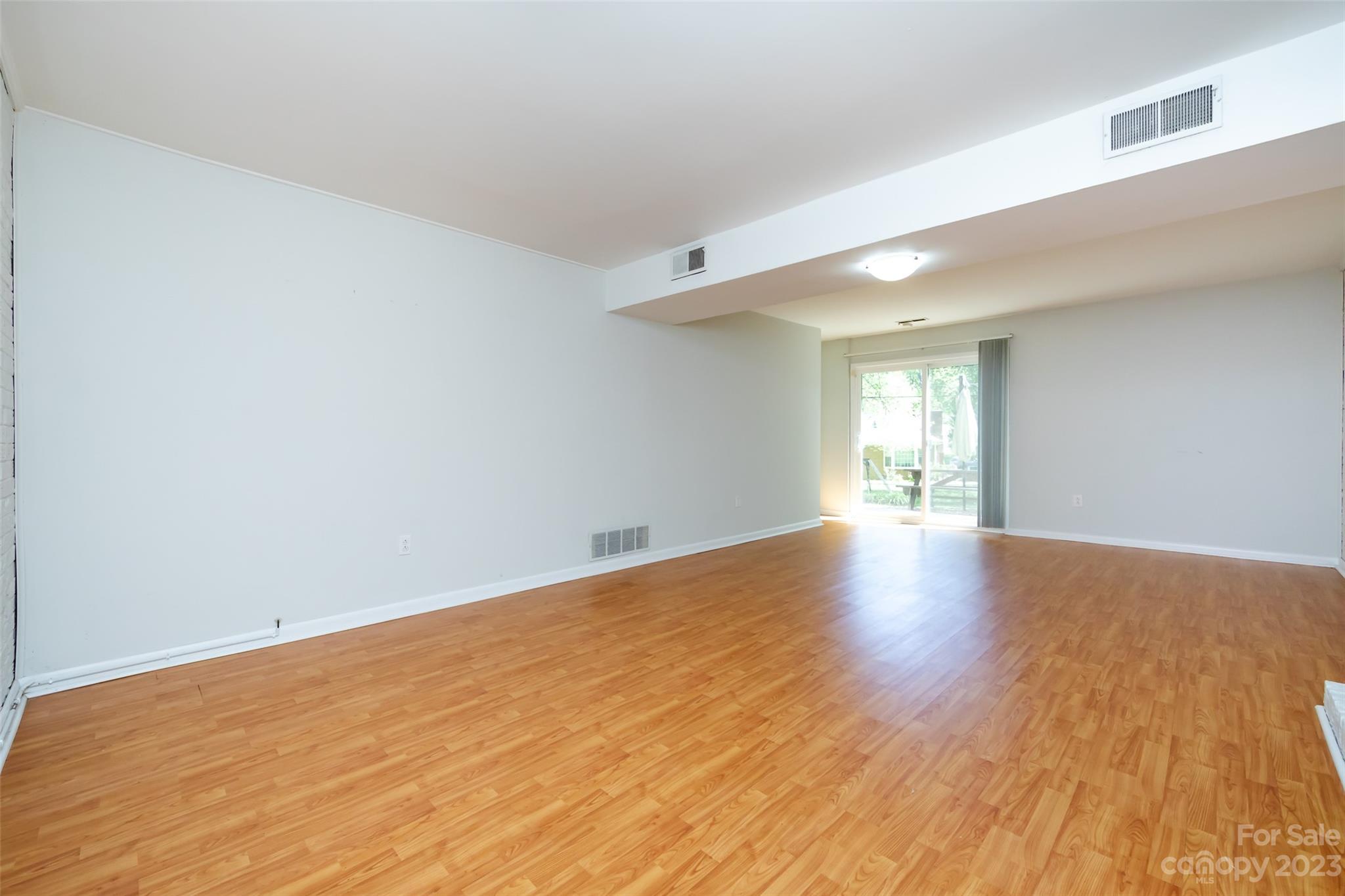 1506 Rama Road Charlotte, NC 28211 - Photo 30 of 48 a view of an empty room with wooden floor and a window