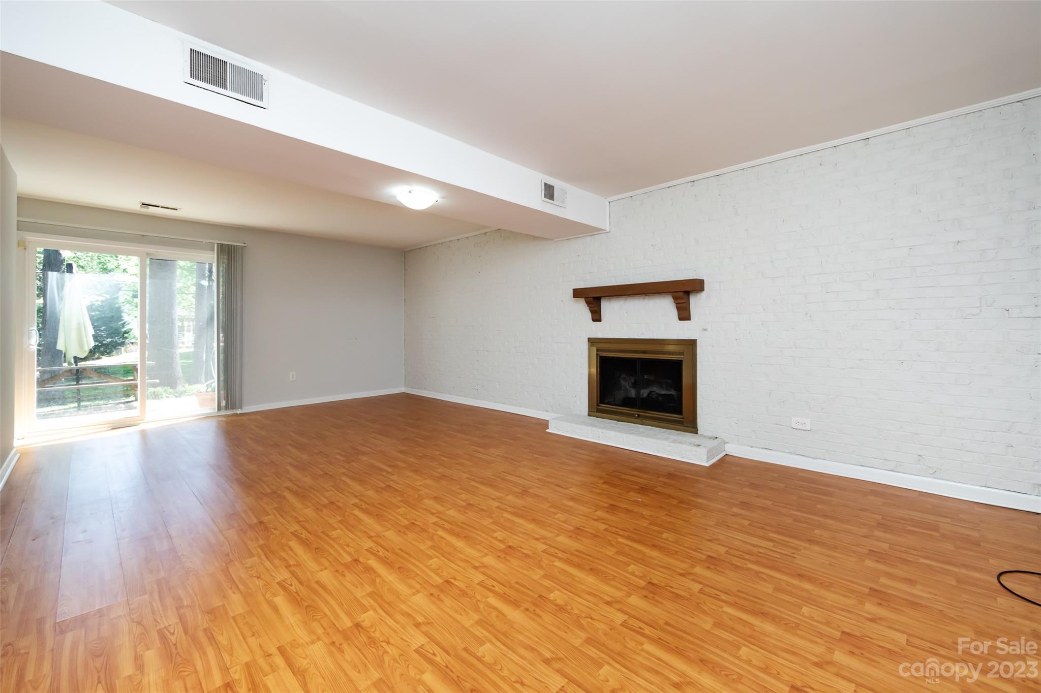 1506 Rama Road Charlotte, NC 28211 - Photo 31 of 48 a view of empty room with wooden floor and fireplace