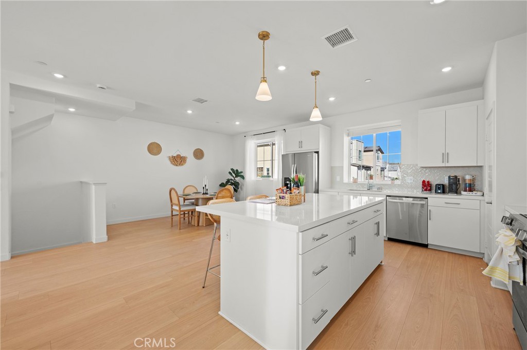 131 Ruby Road Rancho Mission Viejo, CA 92694 - Photo 22 of 65 a kitchen with white cabinets and sink