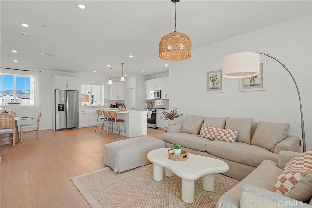 131 Ruby Road Rancho Mission Viejo, CA 92694 - Photo 27 of 65 a living room with furniture kitchen view and a chandelier