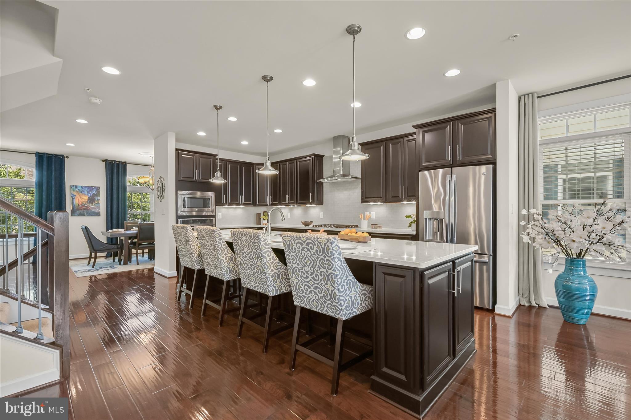 11285 Terrace Lane Fulton, MD 20759 - Photo 15 of 52 a dining room with stainless steel appliances kitchen island granite countertop a dining table chairs and a refrigerator