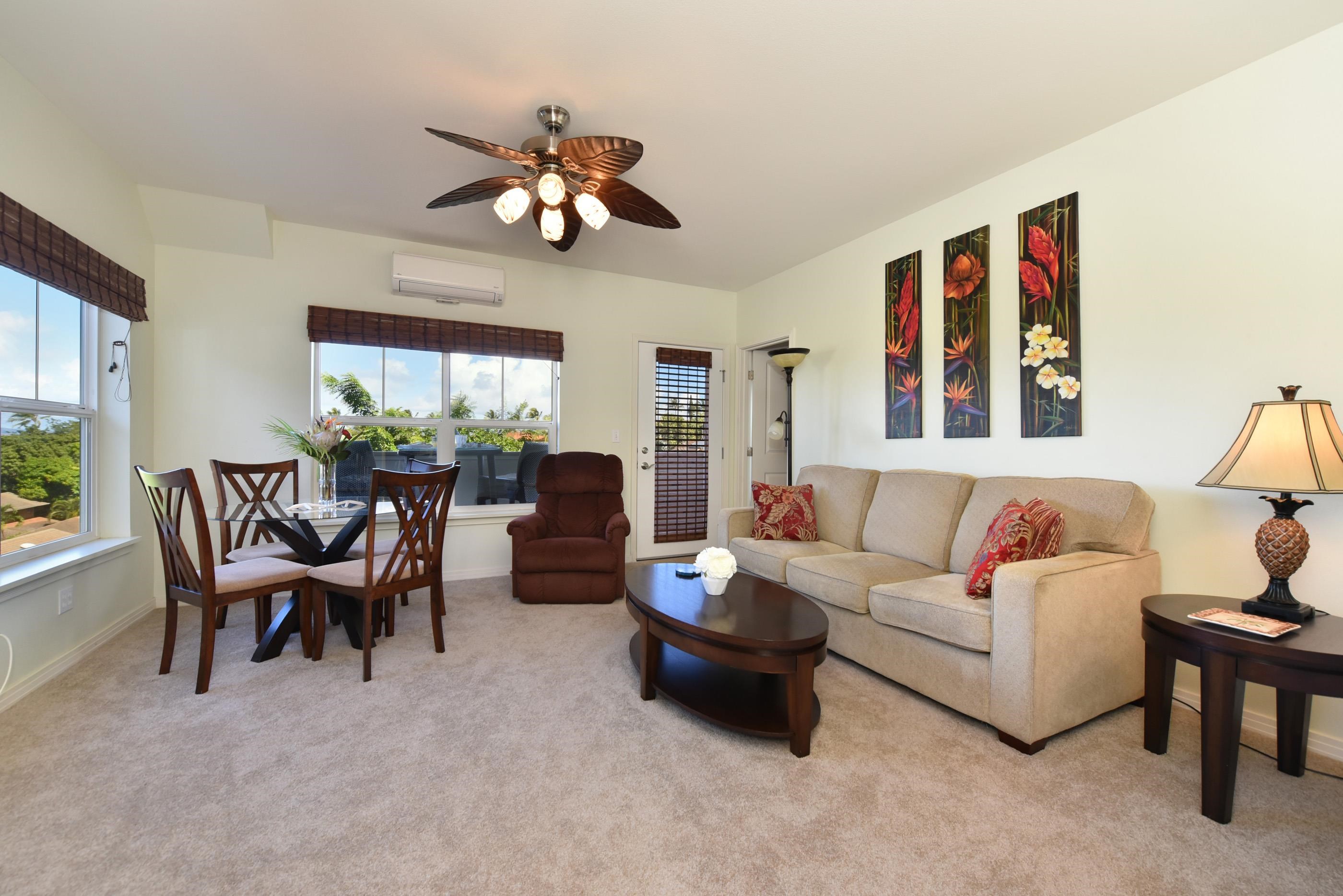 3708 Lower Honoapiilani Road, Unit E30 Lahaina, HI 96761 - Photo 11 of 30 a living room with furniture a chandelier and a large window