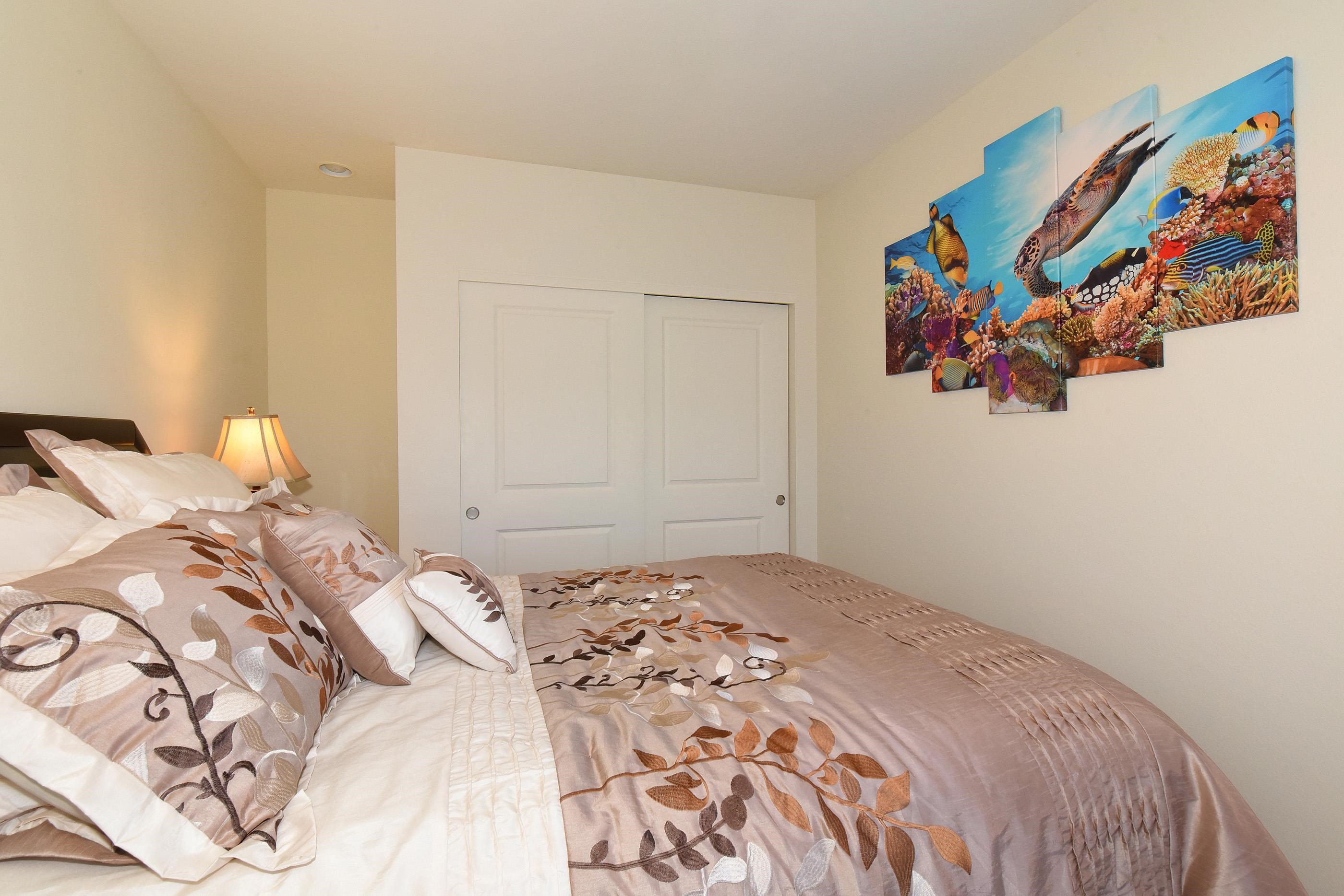 3708 Lower Honoapiilani Road, Unit E30 Lahaina, HI 96761 - Photo 24 of 30 a bedroom with a bed and a painting on the wall