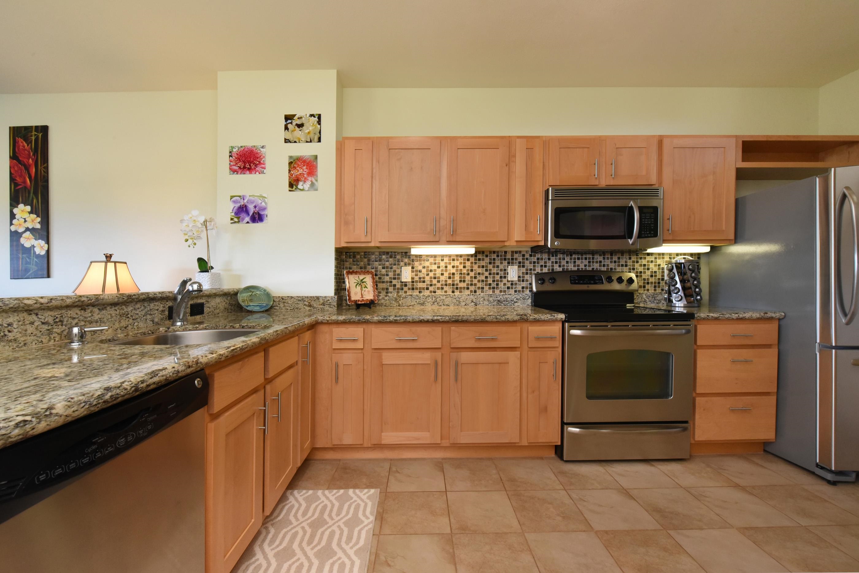 3708 Lower Honoapiilani Road, Unit E30 Lahaina, HI 96761 - Photo 6 of 30 a kitchen with granite countertop a sink and a stove top oven