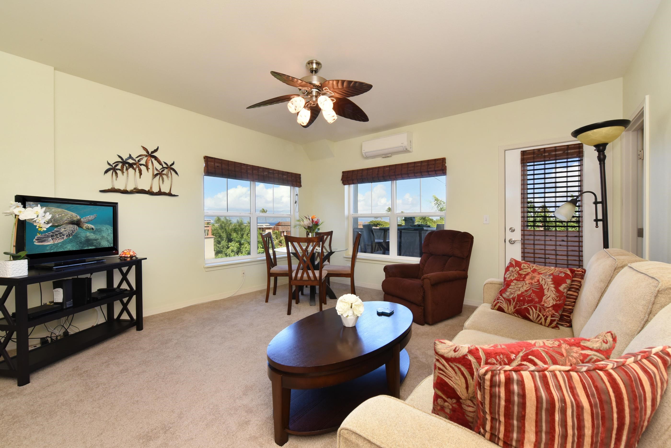 3708 Lower Honoapiilani Road, Unit E30 Lahaina, HI 96761 - Photo 10 of 30 a living room with furniture a flat screen tv and a window