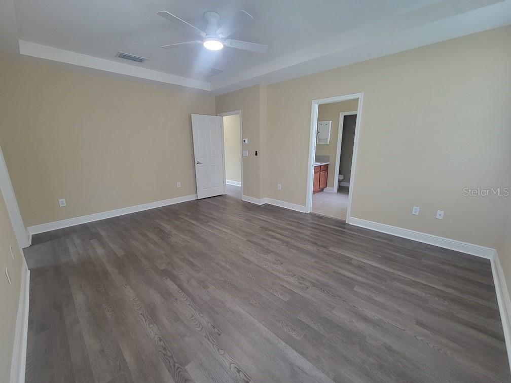 10418 Fenceline Road New Port Richey, FL 34655 - Photo 23 of 36 a view of an empty room with wooden floor