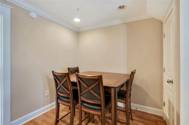 a view of a room with table and chairs