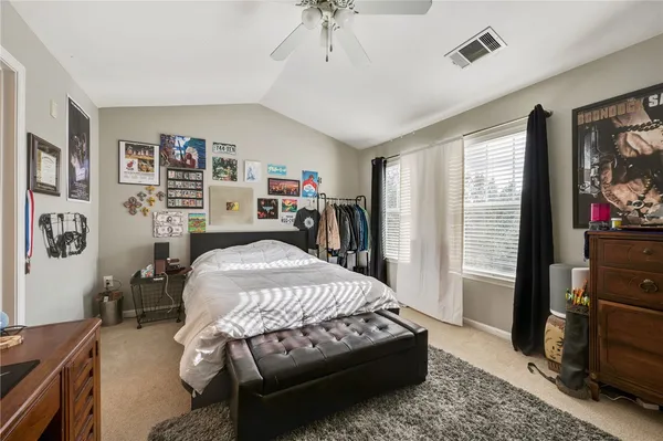 a bedroom with bed and a window