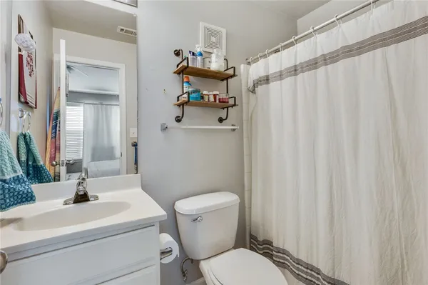a bathroom with a sink toilet and mirror