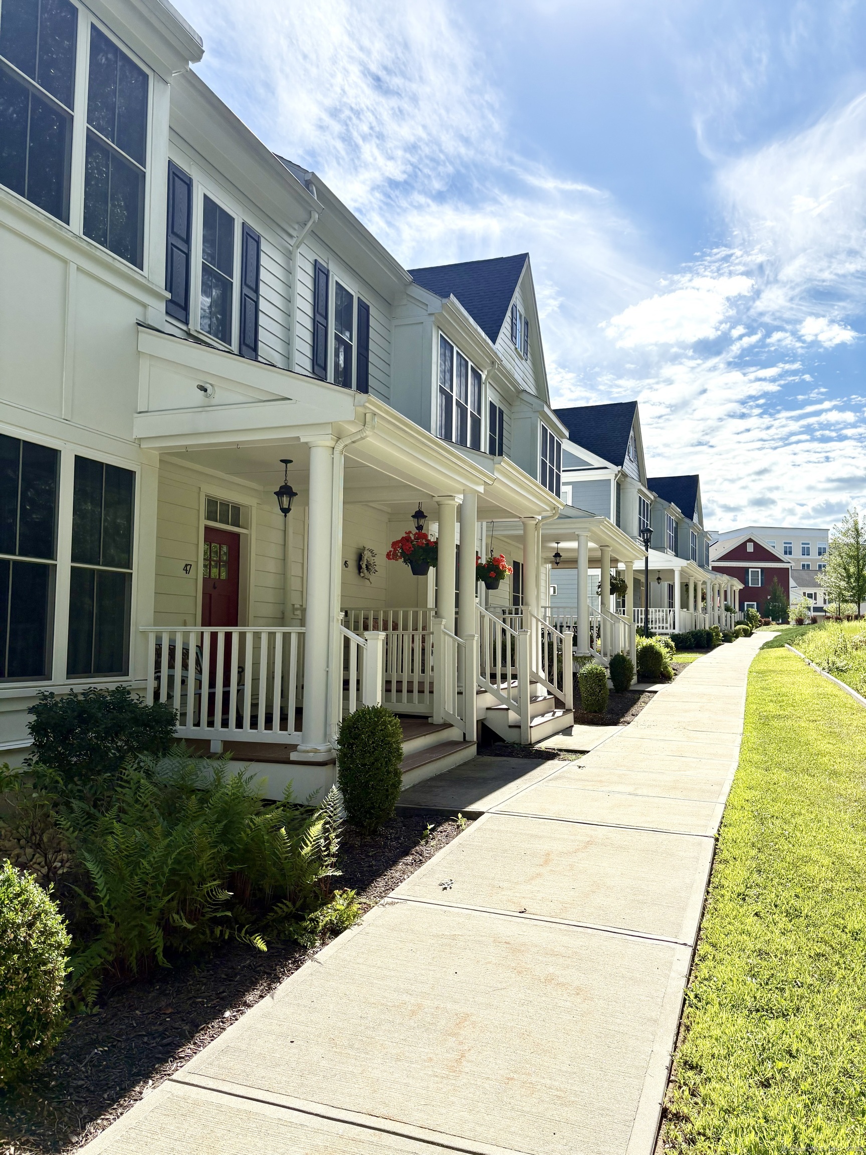 a front view of a building with a garden