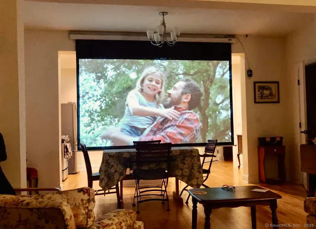 a view of a dining room with furniture and chandelier