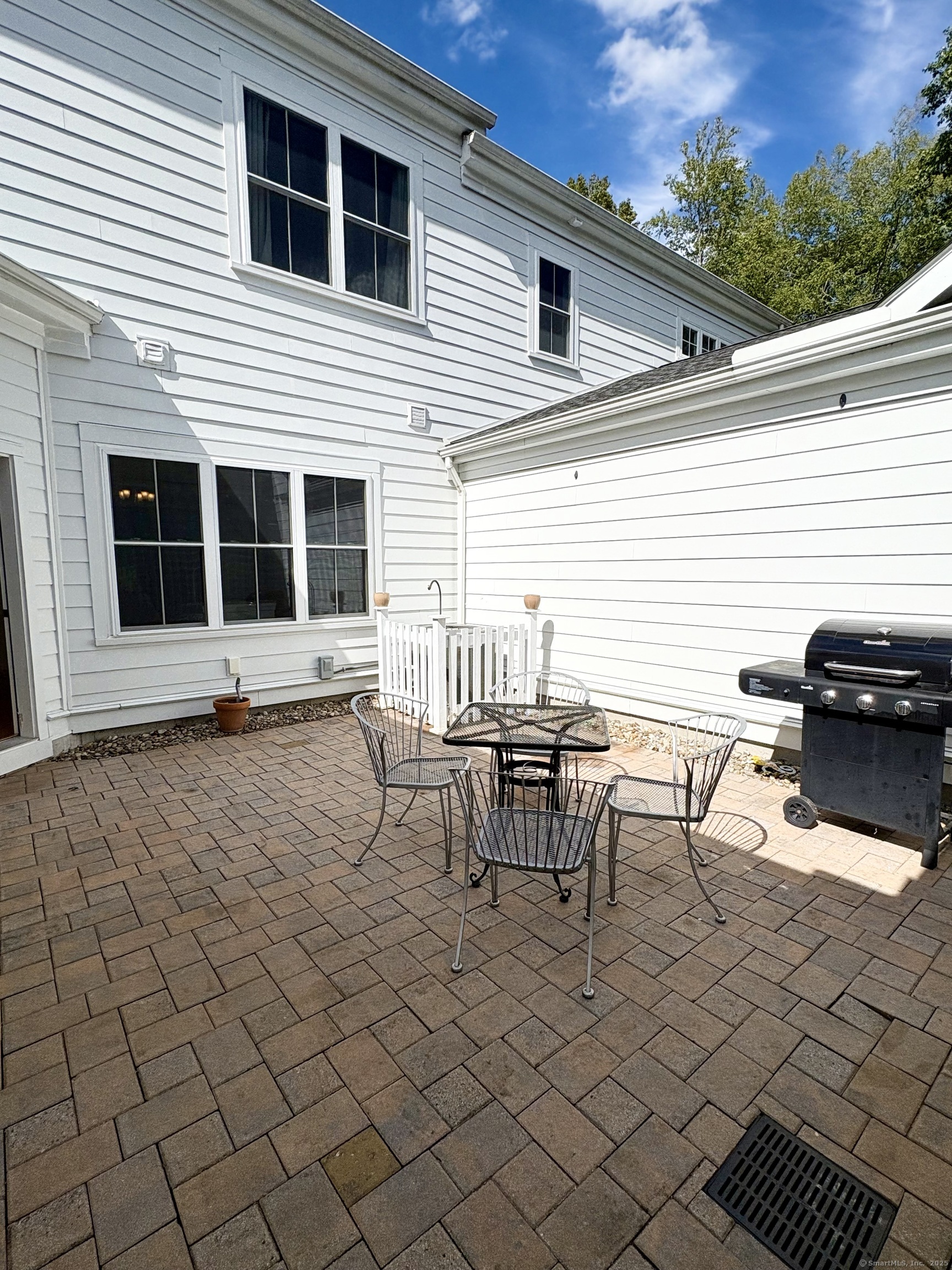 47 Sherwood Street, Unit 47 Mansfield, CT 06268 - Photo 8 of 21 a view of a patio with table and chairs