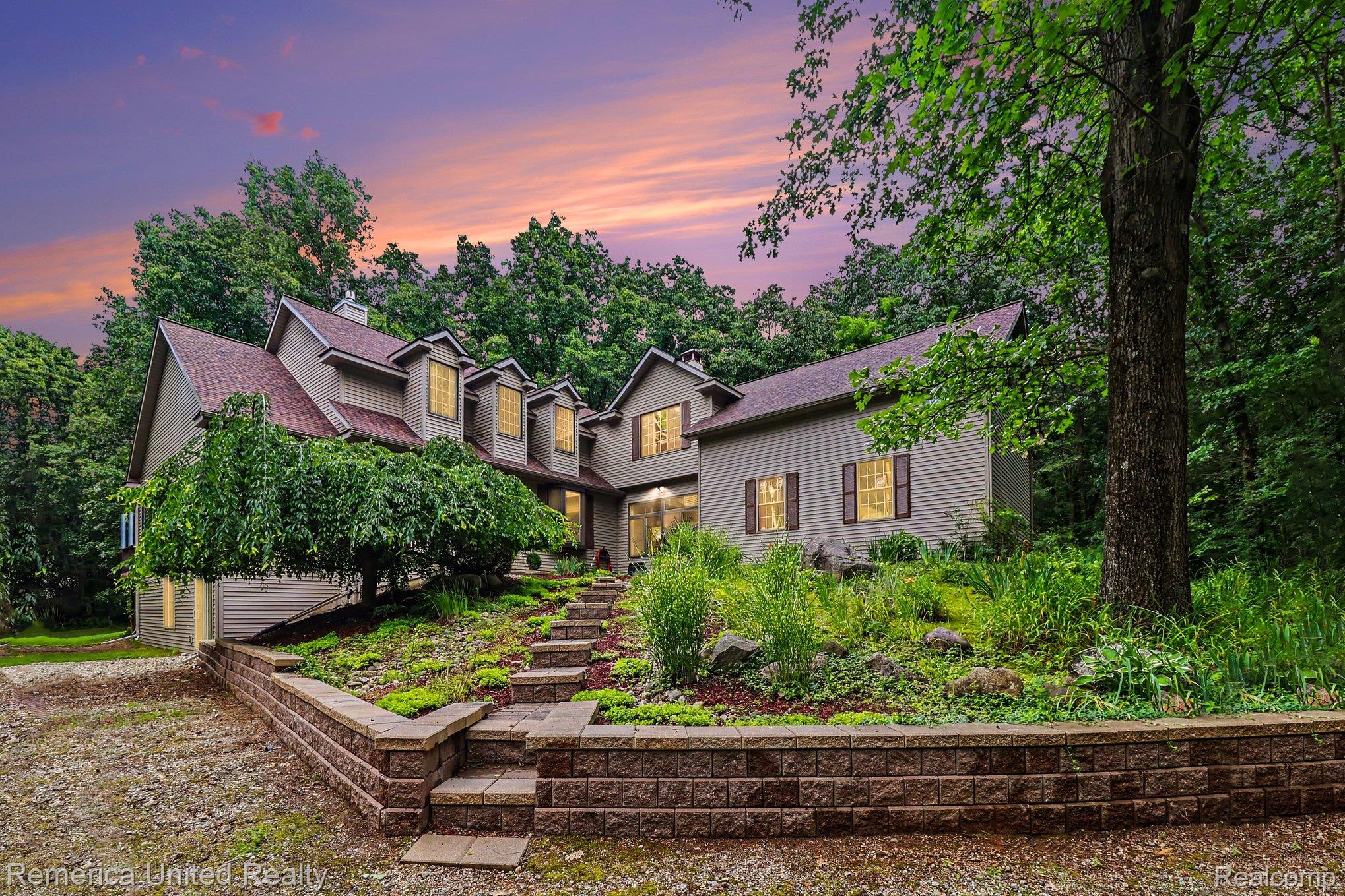 20962 Wasson Road Gregory, MI 48137 - Photo 1 of 39 Multi-level residence with dormer windows, surrounded by mature trees