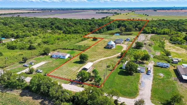 an aerial view of a houses with a yard